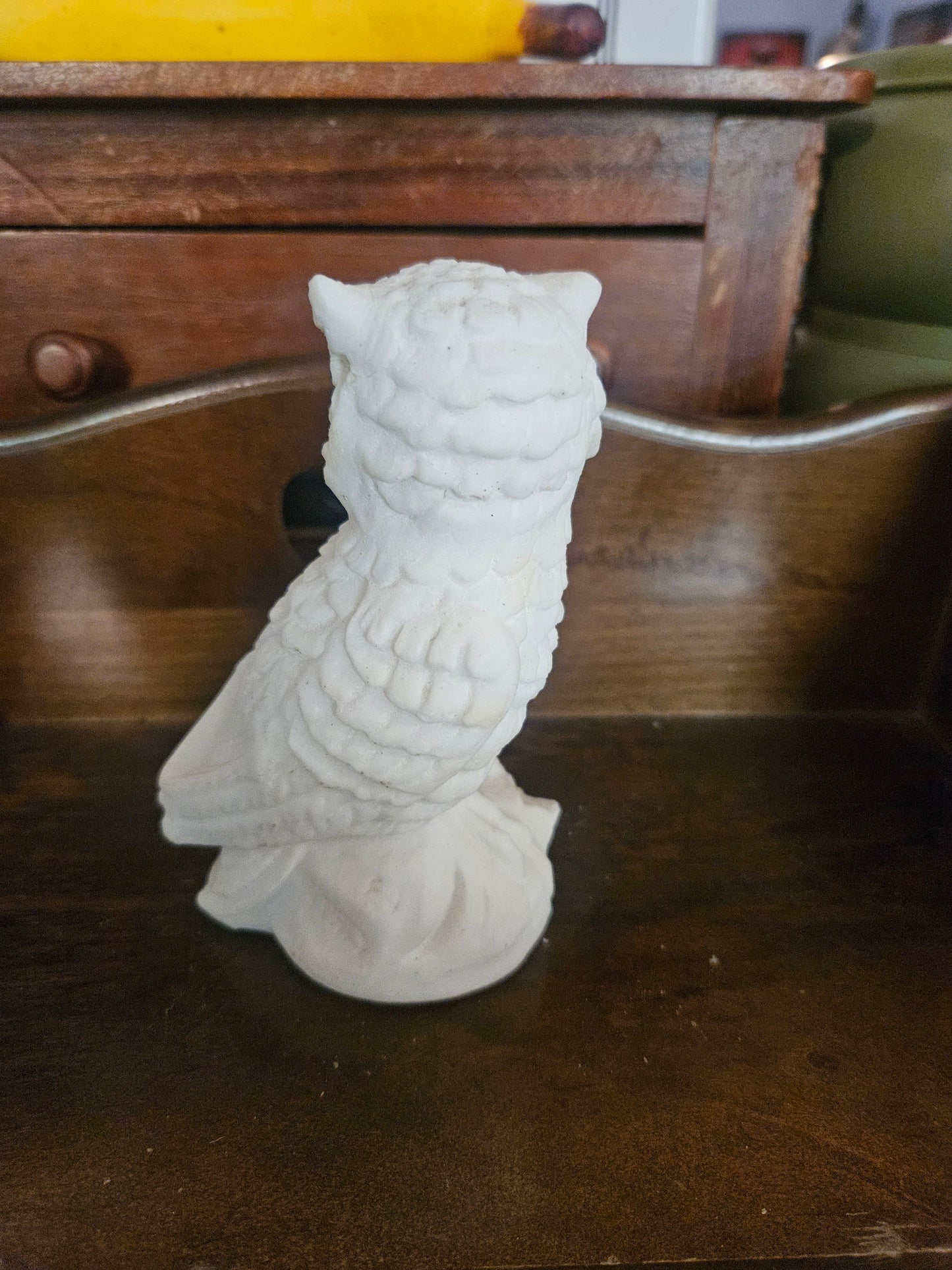 Back view of vintage white chalkware owl figurine showing feather texture detail