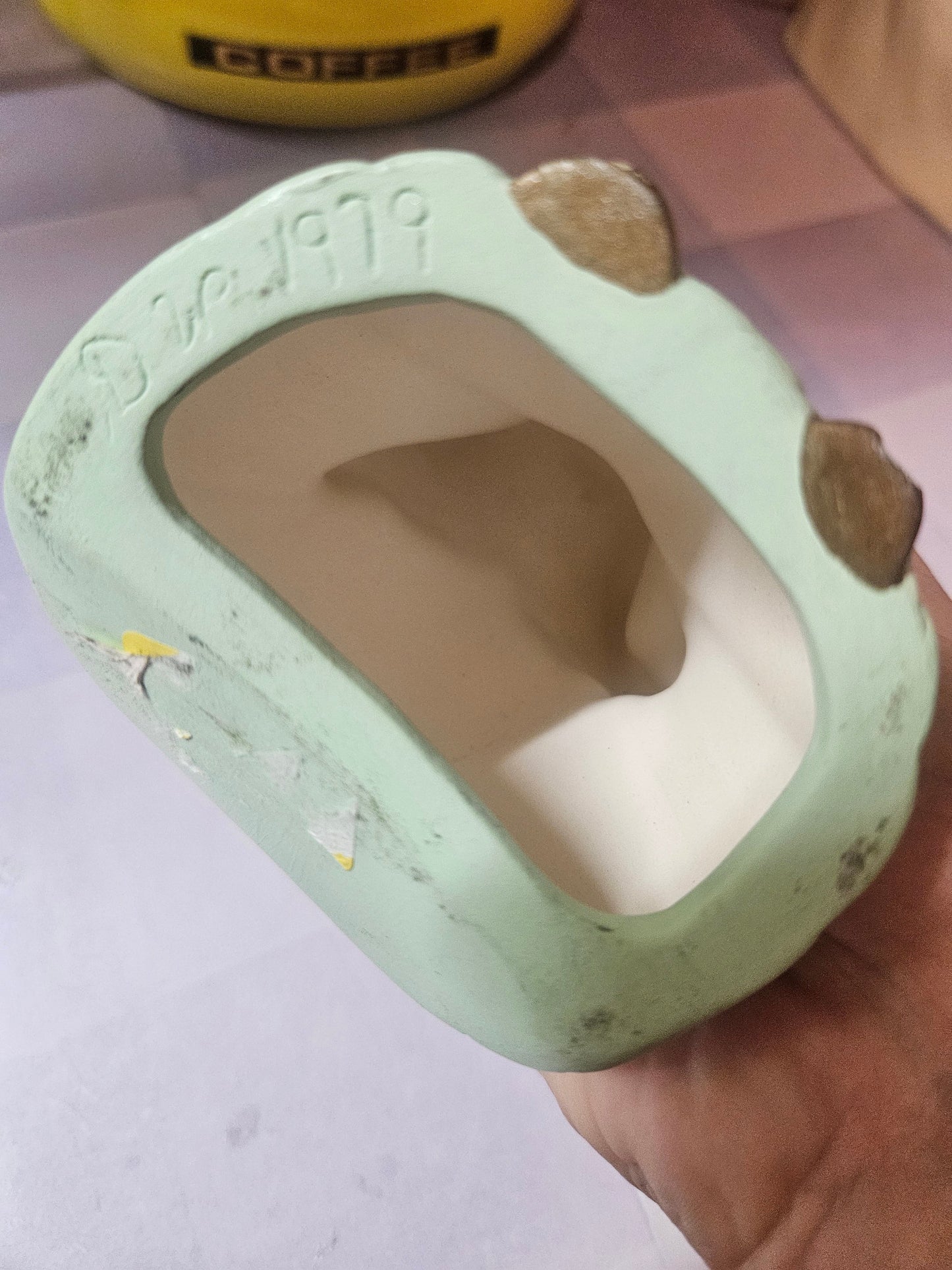 Bottom view showing hollow base with copyright 1979 marking and chips on edges