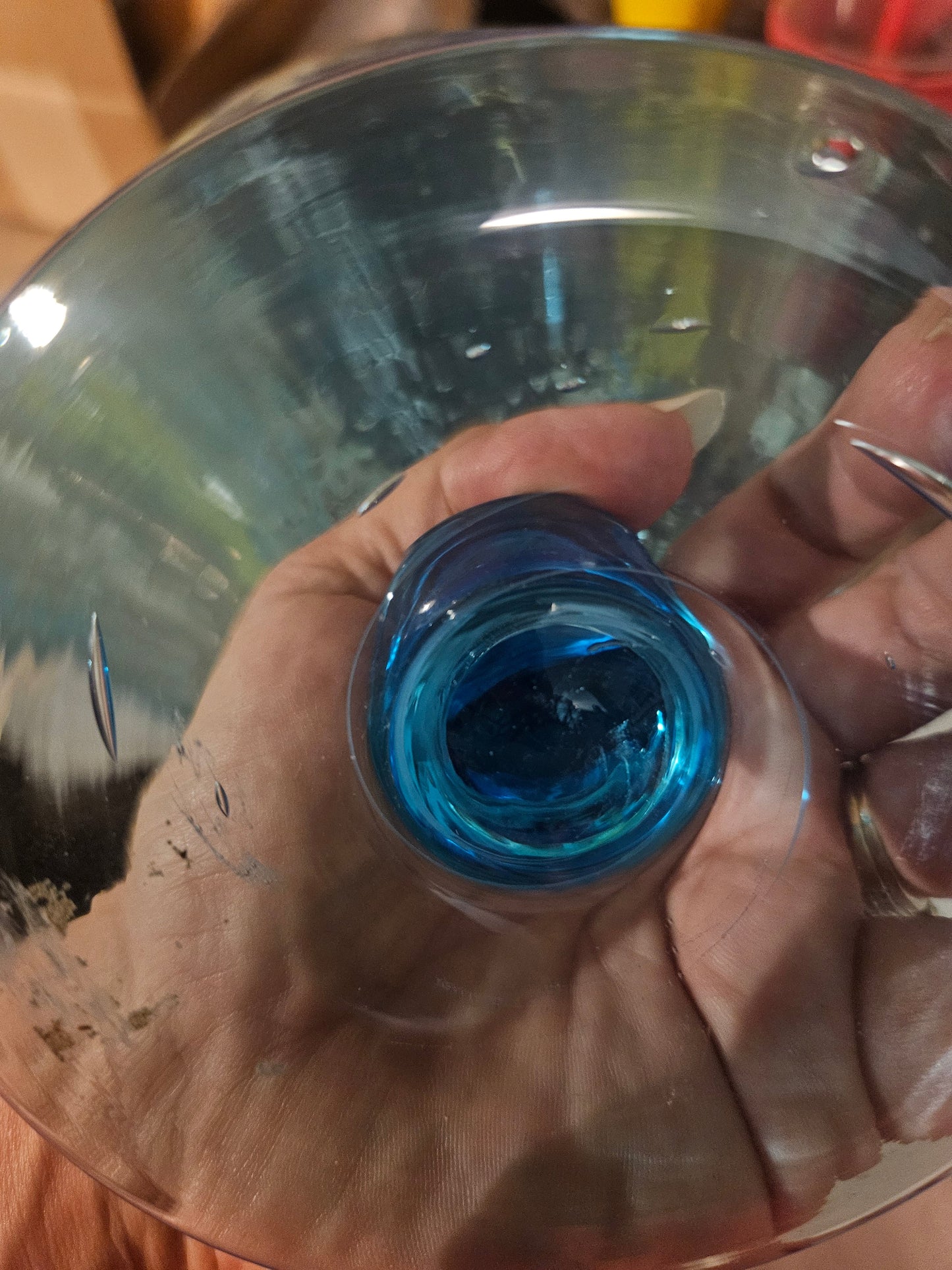 Bottom of aqua blue apothecary jar base showing manufacturing irregularity swirl in glass pontil area