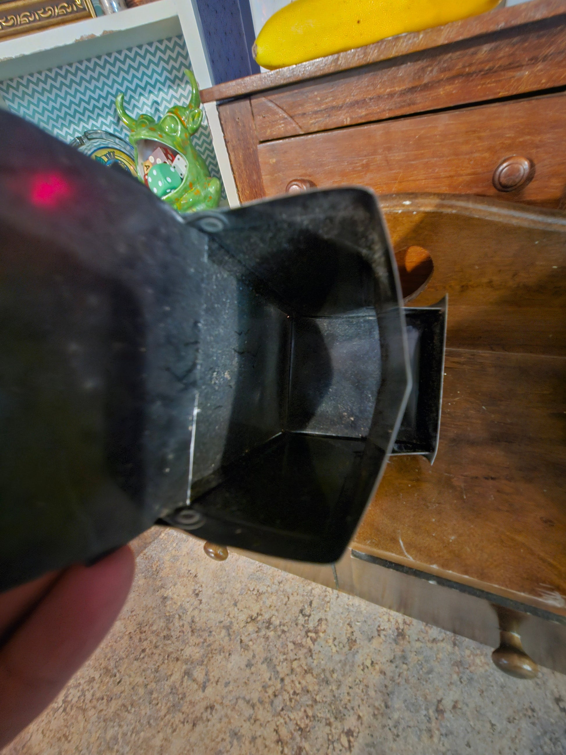 Interior bottom of Coca-Cola napkin holder showing open dispenser slot
