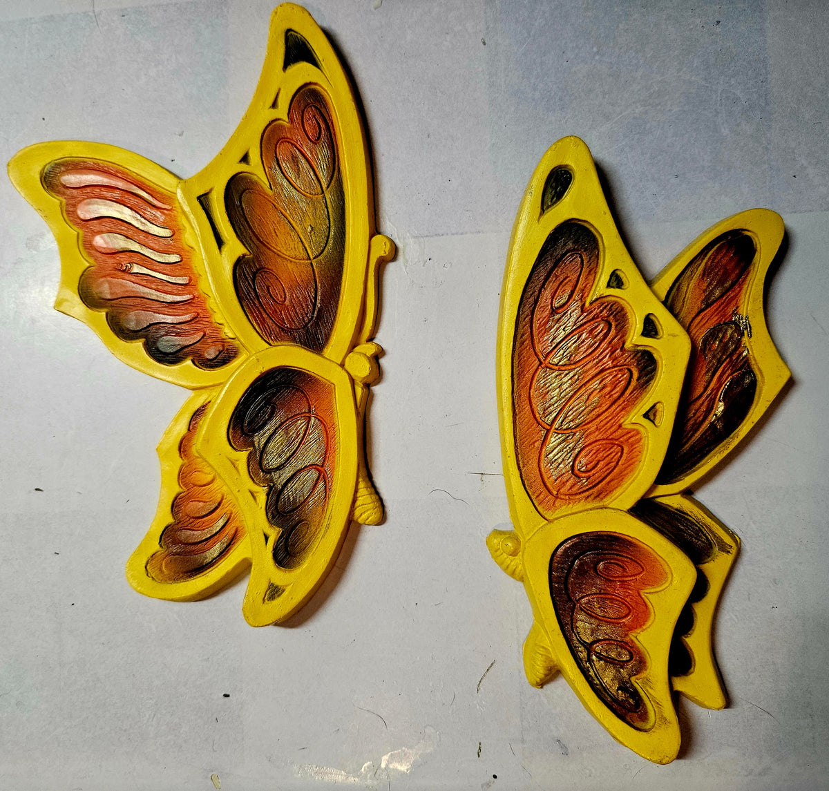 Back of Universal Statuary butterfly wall plaques showing maker mark and metal D-ring hangers