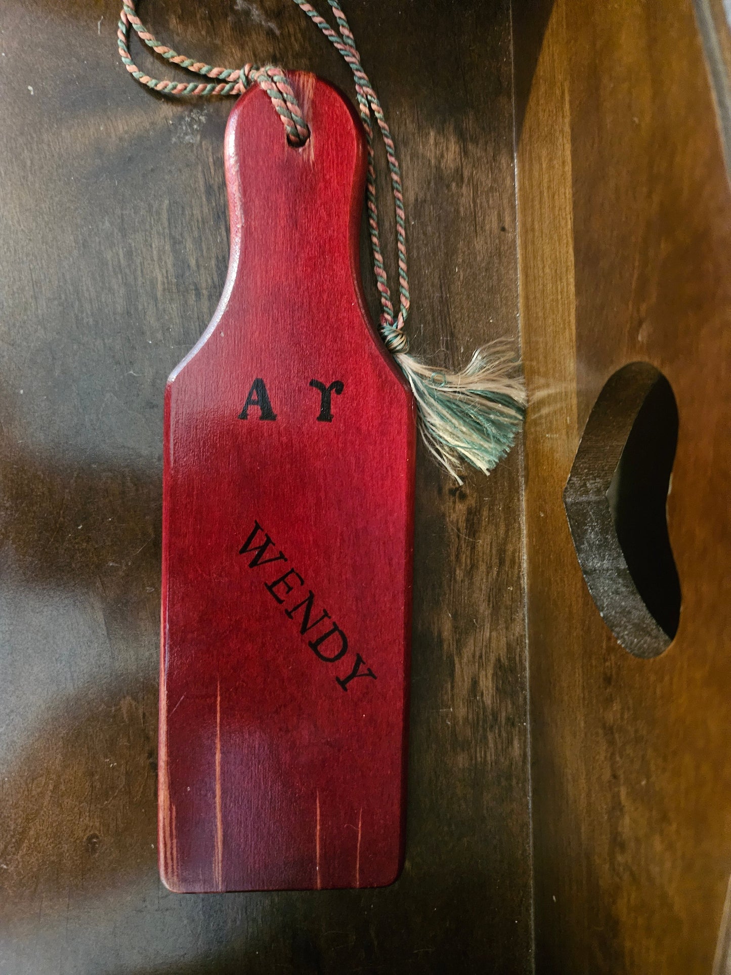 Back of vintage Alpha Chi Omega sorority paddle showing A Gamma Wendy personalization with braided rope and tassel