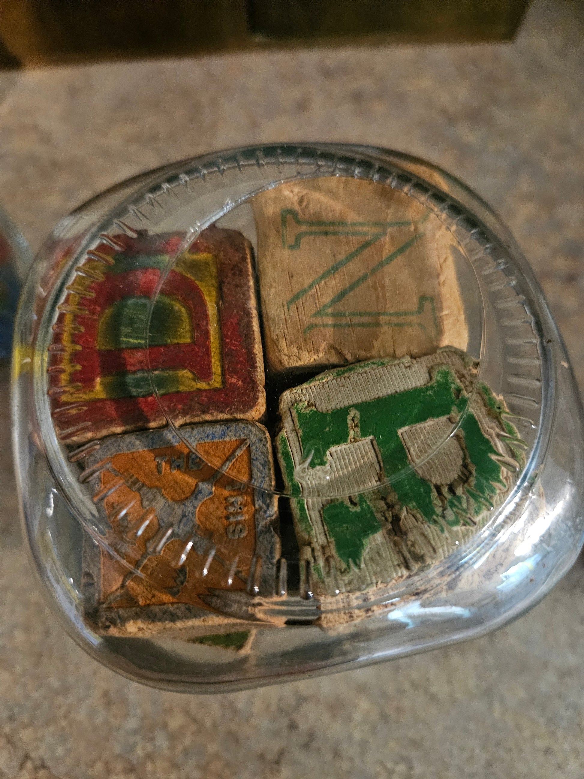 Top view of jar showing D, N, T letter blocks with colorful painted borders