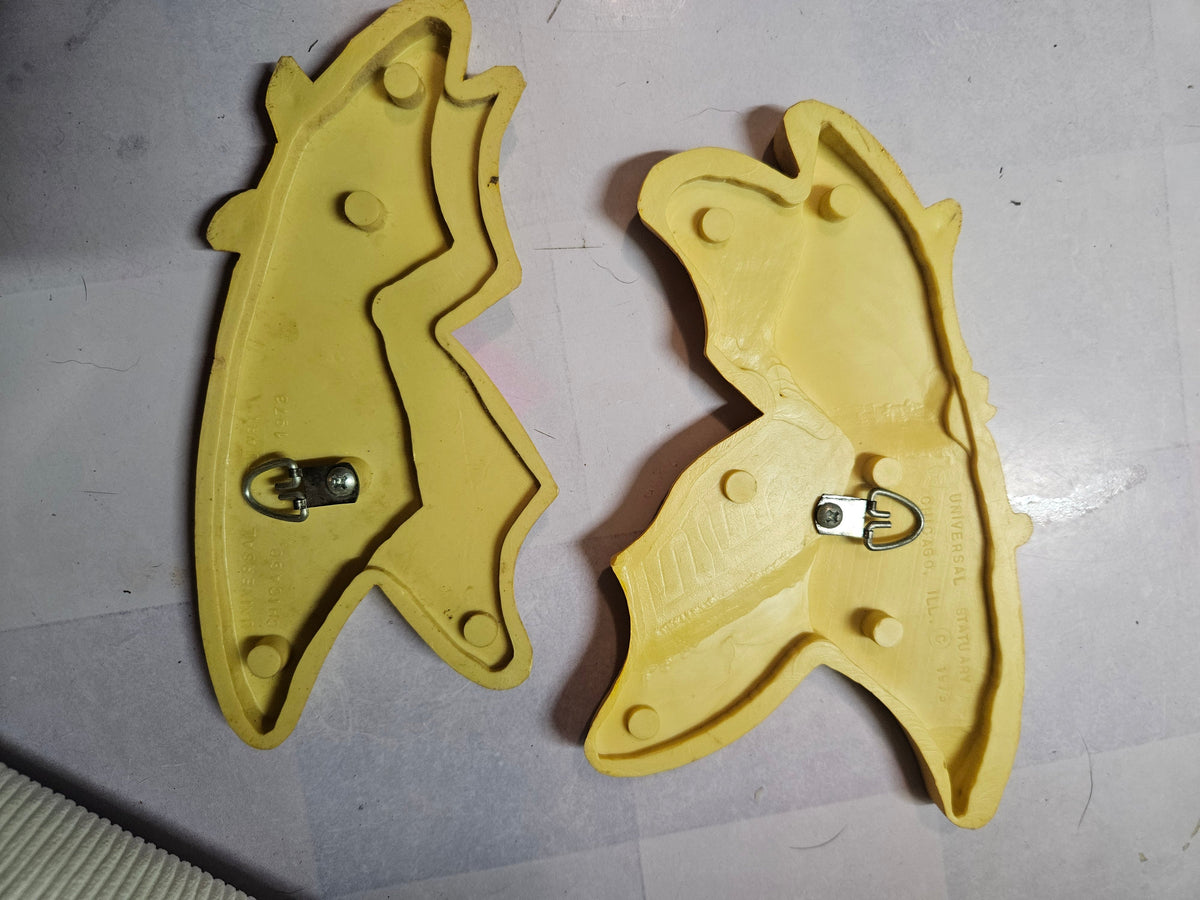 Pair of vintage MCM Universal Statuary butterfly wall plaques in yellow, orange, and brown, front view